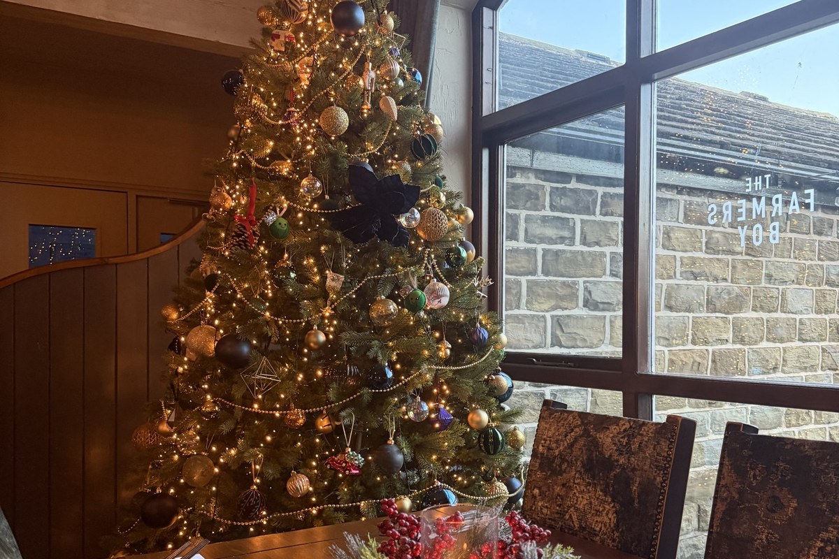A decorated Christmas tree beside a festive dining table at The Farmers Boy